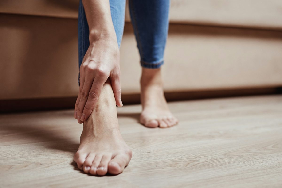 Woman have pain in leg, take ankle massage